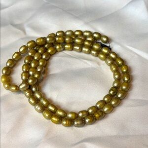 Khaki-colored fresh water pearl necklace with silver clasp.
